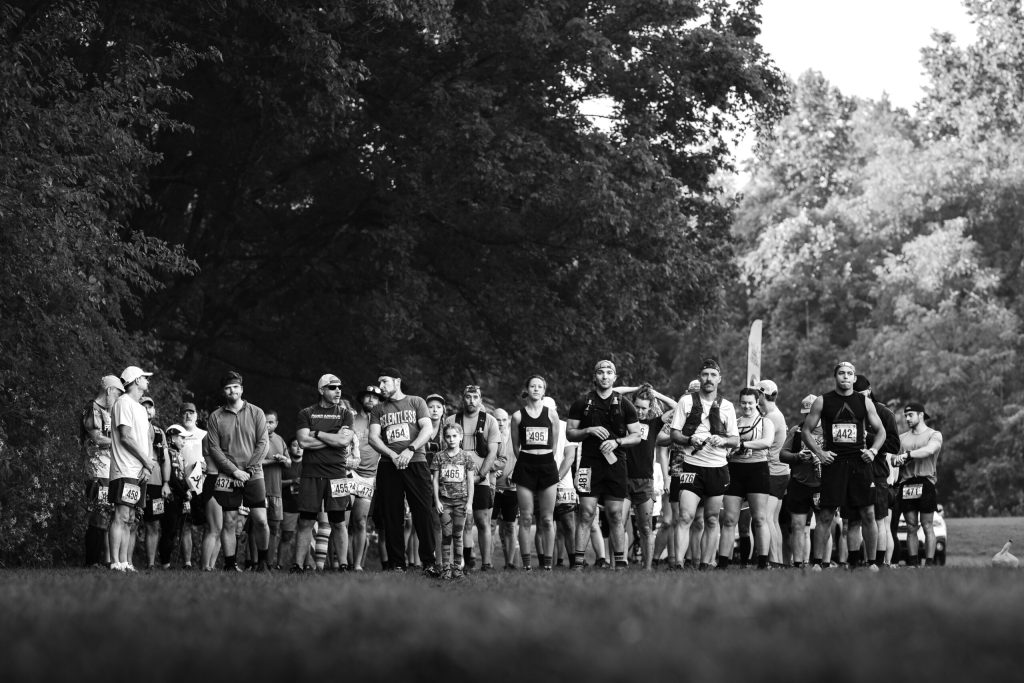 a group of runners with trees in the distance